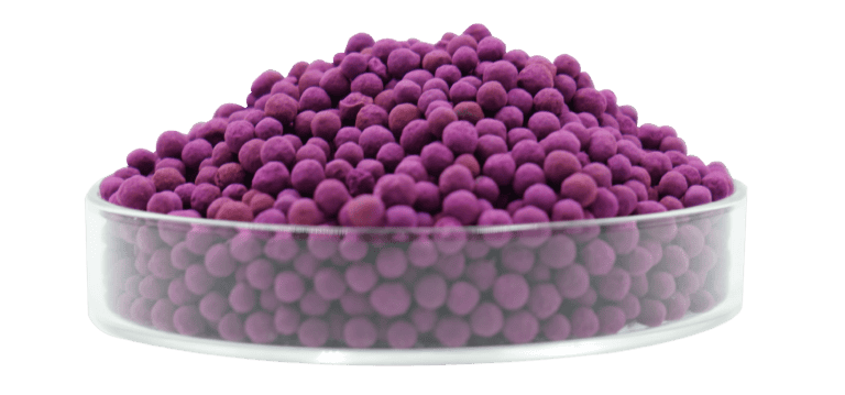 Purple antibacterial ceramic balls in a clear petri dish for air and water purification - Circul-Aire eco-friendly air purification system.