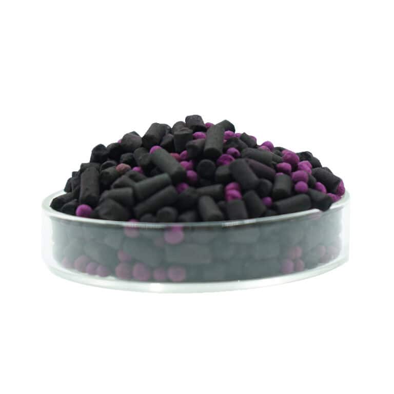 Small black and purple activated charcoal pellets in a petri dish, used for air purification and odor control by Circul-Aire.